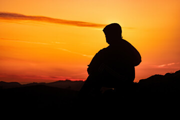 Silhouette of a lonely person at sunset