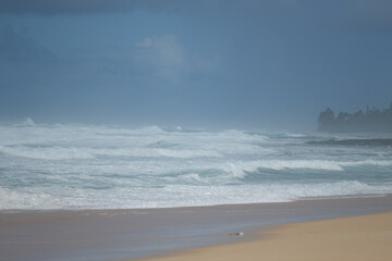 a beach with waves crashing on the shore