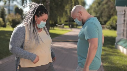 Friends in protective medical face mask greet their elbows. Social distancing. Elbow bump is new greeting to avoid spread of coronavirus or covid-19 - Avoid or Stop handshakes due to pandemic.