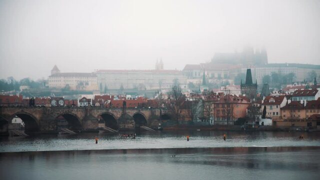 Magnifficent panorama of old european town on foggy winter day. Amazing view on small buildings, still river with stone bridge. Atmosphere of christmas holiday season, cozy place for tourists.