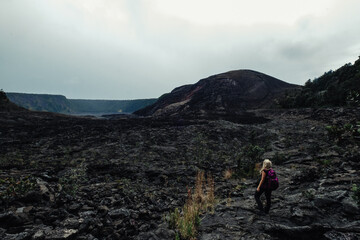 Fototapeta premium a woman walking on a rocky path