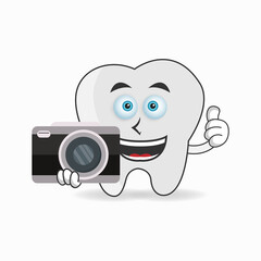 Tooth mascot character holding camera. vector illustration