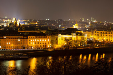 Fototapeta na wymiar Night Prague City with its Cathedrals, Towers and Bridges in the Christmas Time, Czech Republic
