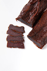 Sliced jerky meat on a white plate. Beer snack. Meat for sandwiches.