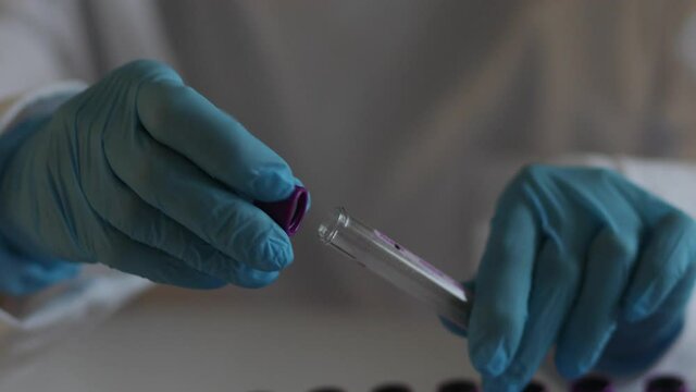 Process of coronavirus testing examination by nurse medic in laboratory lab, COVID-19 swab collection kit, test tube for taking OP NP patient specimen sample, patient receiving a corona test
