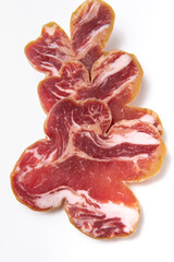 Sliced jerky meat on a white plate. Beer snack. Meat for sandwiches.