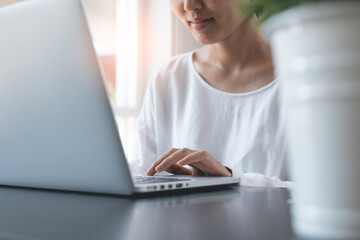 Asian business woman working on laptop from home office