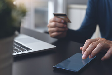 Man using credit card for digital banking via mobile phone 
 app for online shopping Internet payment concept