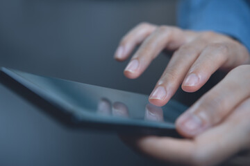 Close up image of woman finger touching on mobile phone screen