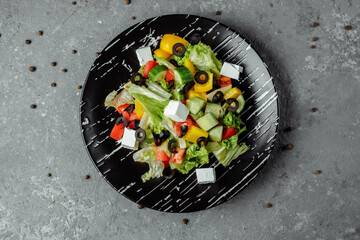 Greek Salad with Cucumeber, Kalamata Olives, Feta Cheese, Juicy Cherry Tomatoes and Fresh Basil. Concept for a tasty and healthy vegetarian meal
