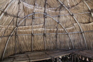 The wall inside the tiki hut.