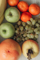 Composition with Summer Colorful Fresh Fruits on Wooden White Background