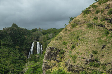 a waterfall in a green valley