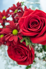 bouquet of flowers. red roses and red daisies