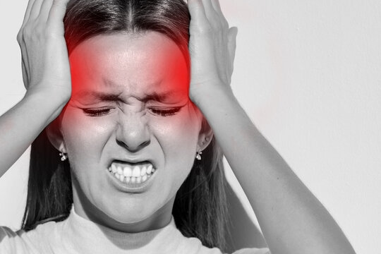 Woman touching her temples, having strong tension headache. Cluster headache, migraine. Hands on head
