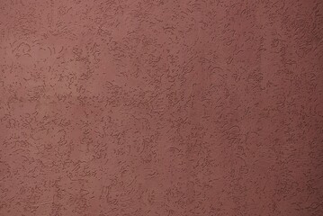 brown plaster texture on the wall of a building on the street
