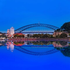 Sydney Harbour Bridge at night NSW Australia reflection in the harbour waters