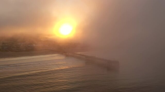 Obscured sunrise at Pismo Beach Pier in California during wildfires