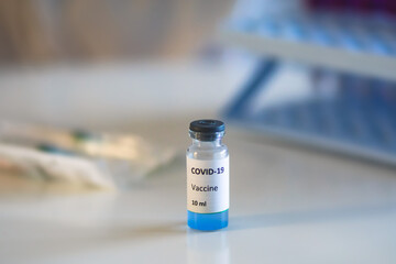 Concept of Covid 19 vaccine vaccinating, development and creation, doctor or scientist in laboratory holding a single dose of  2019-ncov vaccine, a syringe and ampule with SARS-CoV-2 vaccination