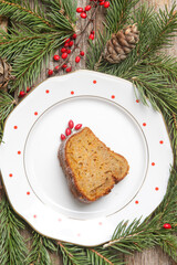 Fototapeta na wymiar A slice of bundt cake on plate in festive wintery Christmas arrangement. 