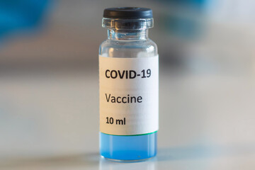 Concept of Covid 19 vaccine vaccinating, development and creation, doctor or scientist in laboratory holding a single dose of  2019-ncov vaccine, a syringe and ampule with SARS-CoV-2 vaccination