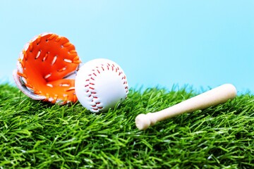 Baseball is on green grass blue sky background