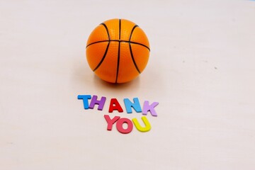 Basketball with thank you word on wooden background