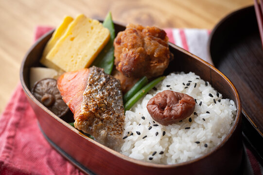 Japanese Style Bento In Wooden Box With Salmon And Fried Chicken