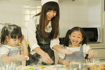 Children and mother cooking in the kitchen