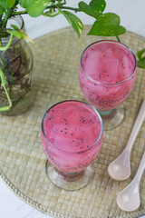 Es Jelly Kelapa Muda or Young coconut ice syrup, Indonesian popular drink, especially for breakfasting during ramadan month. Grainy from the glass. White marble background.