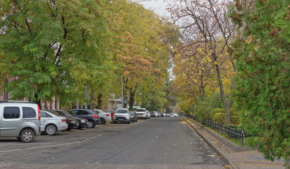Pushkinskaya Street in autumn day. On the street there are cars
