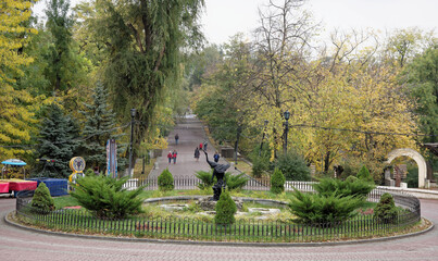 Pedestrians walk along Gorky Park in the autumn day