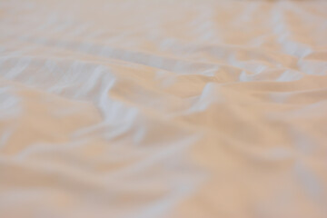 White linen background with copy space, Creased white cloth material fragment as a background, Top view of bedding sheets and pillow