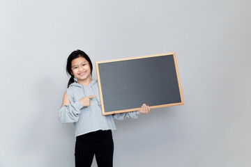 Portrait Of Smiling Girl Holding Blackboard