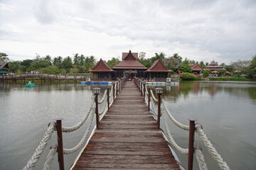   Lake in the park. Tourists drink tea and look at fish in the water