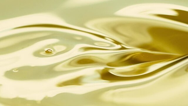 Close-up pouring golden olive oil liquid in slow motion, healthy food background
