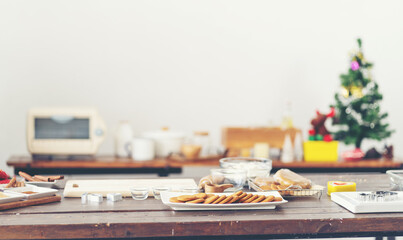 Sweet colourful Christmas gingerbread cookies on wooden dish in kitchen at home. Merry Christmas and Happy New Year