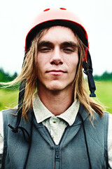 Close-up of the face of an extreme mountain biker in the mountains in a helmet.