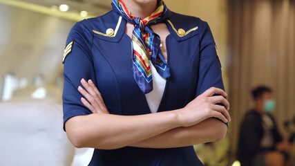 Cabin crew or air hostess working in airplane . Airline transportation and tourism concept.