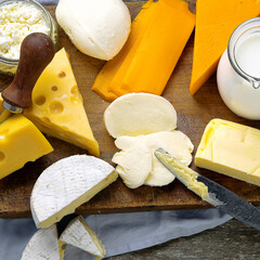 Different types of fresh dairy products on wooden background