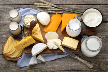 Different types of fresh dairy products on wooden background