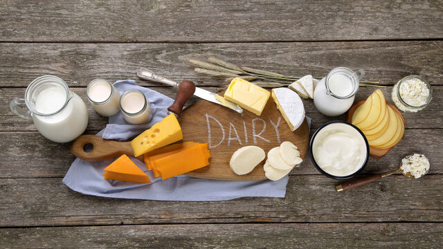 Different types of fresh dairy products on wooden background