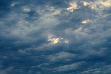 Fototapeta premium Dark clouds in the sky. Dramatic impressive gray background or wallpaper. Natural dangerous and threatening backdrop. The end of a storm, thunderstorm or cataclysm