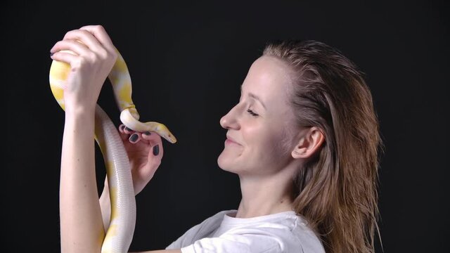 Slow motion video of woman holding albino python