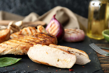 Cooked chicken fillet on wooden table