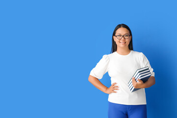 Asian female teacher on color background