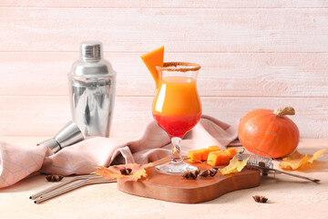 Glass of tasty pumpkin pie martini on table