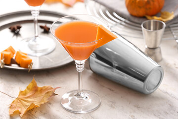 Glass of tasty pumpkin pie martini on table