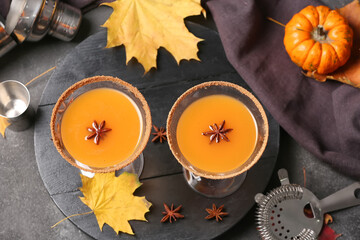 Glasses of tasty pumpkin pie martini on dark background