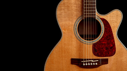 Naklejka premium acoustic guitar with top made of spruce wood with cutaway closeup on black background with copy space